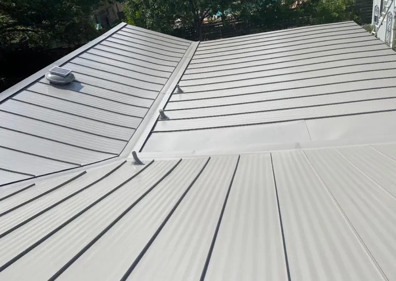 Solar attic fan installed on a metal roof for Roof Ventilation in Price